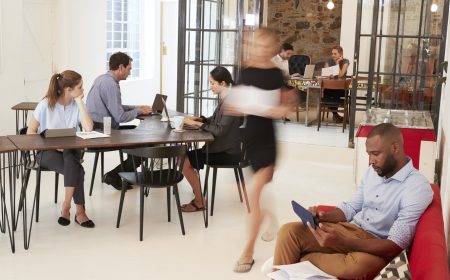 Young professionals working in a busy open plan office